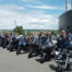 Member's bikes parked near a submarine monument